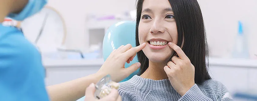A woman discussing the appearance of her smile with a dental professional