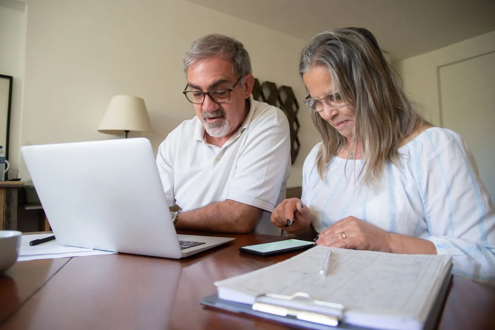 Two adults reviewing paperwork and a budget together